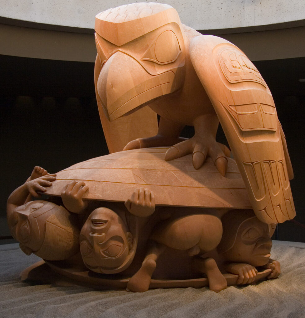 The Raven and the First Men sculpture. A raven sitting on top of a clamshell with humans emerging from inside.